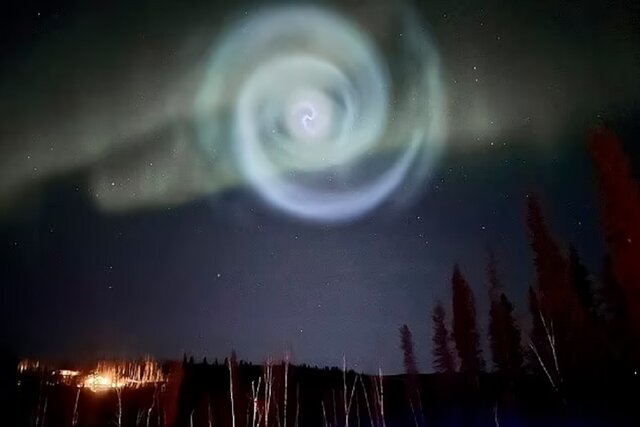 The glow of a mysterious spiral light in the Alaskan sky